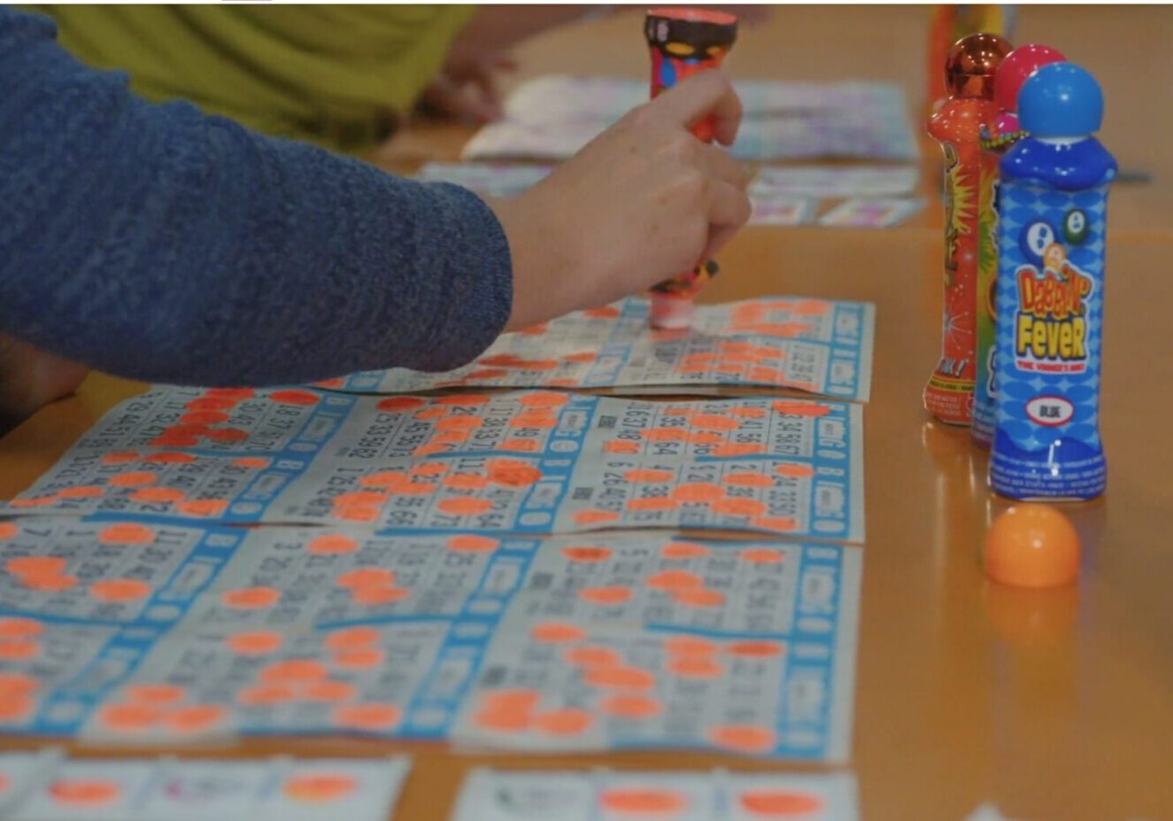 A person is playing bingo on the table